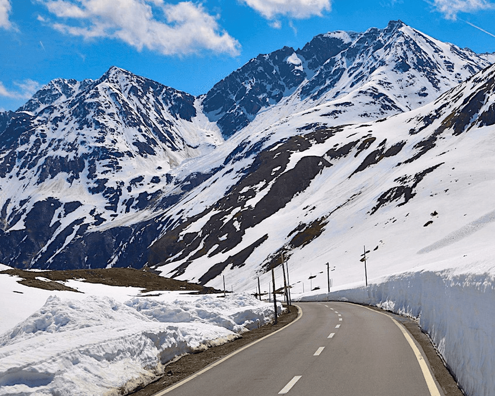 Mountain road between high snow walls near Rohtang Pass, Himachal Pradesh