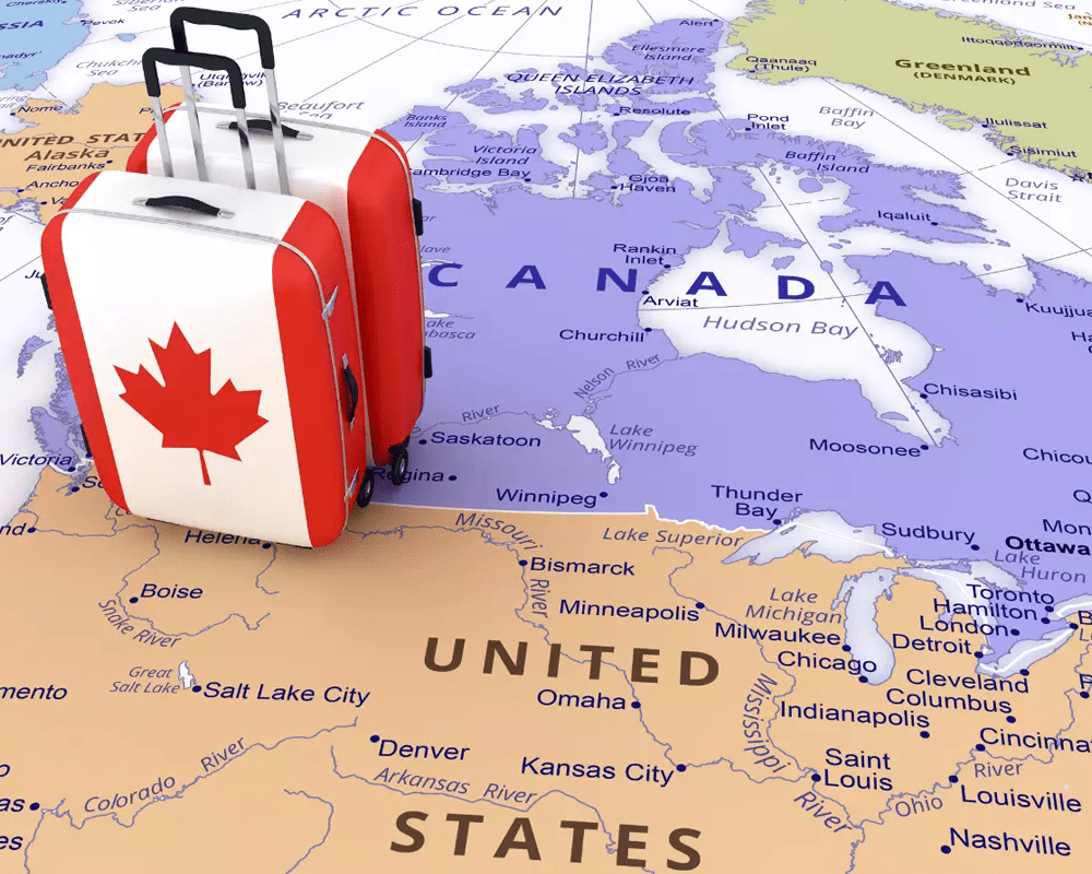 Suitcase with Canadian flag on a map of Canada, Canada immigration